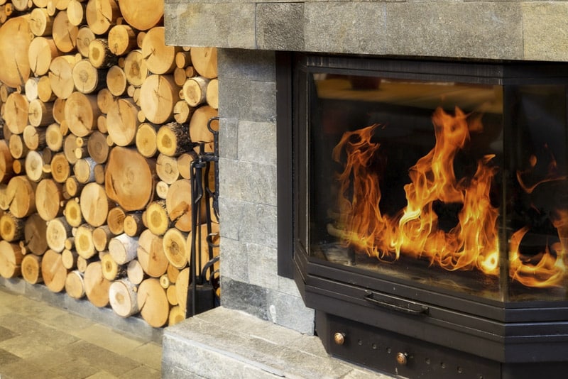 StoneFireplaceWithFlamesOfBurningFireRusticStyleCozy - Chimney Sweeps of America wood fireplace repair Denver, Chimney Sweeps Of America
