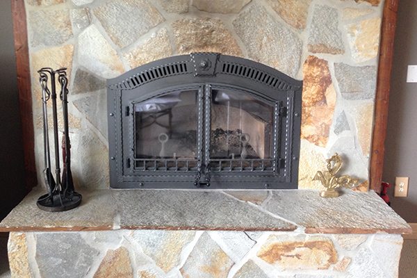 rustic wood fireplace after installation